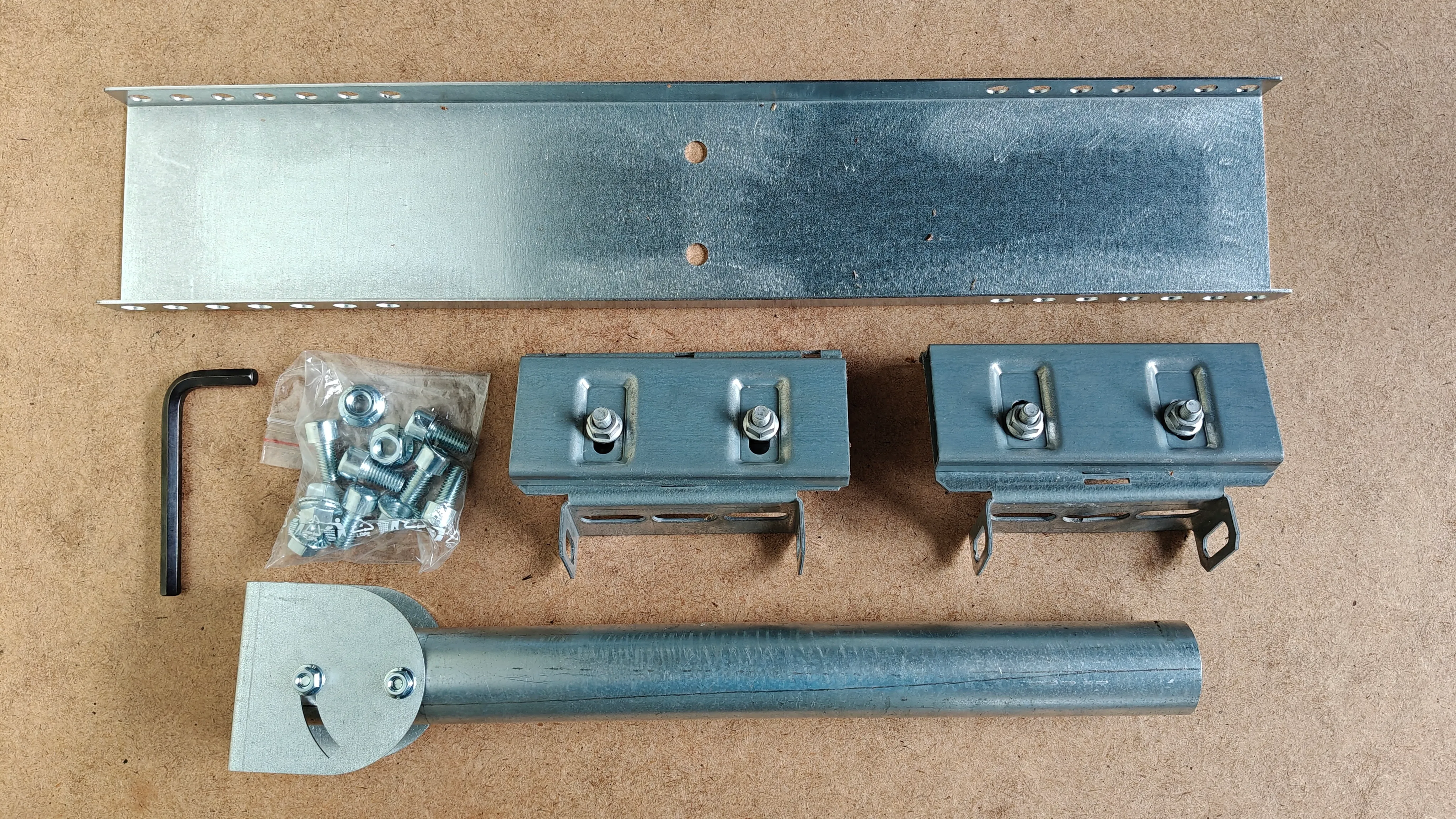 FalsMount kit laid out: two roof clamps, base channel, clevis, 400 mm pole, fastener bag and 8 mm Allen key